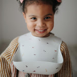 Load image into Gallery viewer, Mushie Silicone Baby Bib - Happyness
