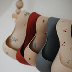 Load image into Gallery viewer, Mushie Silicone Baby Bib - Happyness
